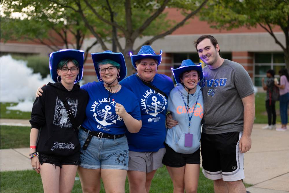 group of students wearing blue cowboy hats